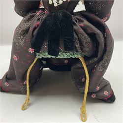 Anna Meszaros Hungary - hand made needlework figurine 'Old Lady' seated on a stool wearing a lace trimmed black/white/red floral full length dress and hat, working on a piece of lace H30cm  Auctioneer's Note: Anna Meszaros came to England from her native Hungary in 1959 to marry an English businessman she met while demonstrating her art at the 1958 Brussels Exhibition. Shortly before she left for England she was awarded the title of Folk Artist Master by the Hungarian Government. Anna was a gifted painter of mainly portraits and sculptress before starting to make her figurines which are completely hand made and unique, each with a character and expression of its own. The hands, feet and face are sculptured by layering the material and pulling the features into place with needle and thread. She died in Hull in 1998.