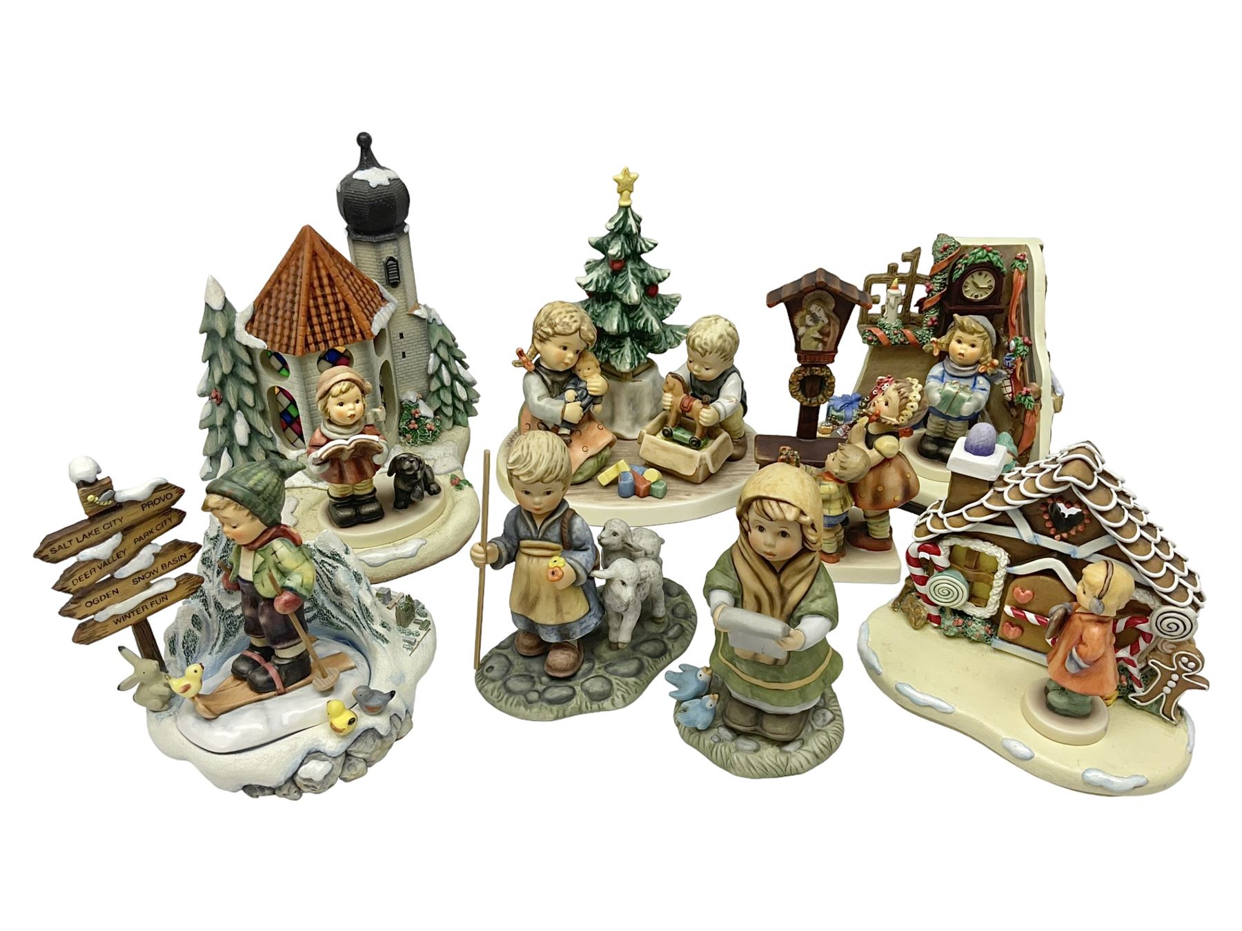 Eight Christmas Hummel figures by Goebel, to include Wintertime Chapel candle holder, Winter Fun, Christmas Morning, Christmas Time and Gingerbread Lane, tallest H21cm