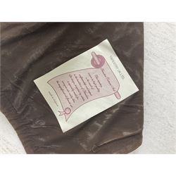 Three tapestries comprising 20th century wool tapestry panel of a medieval nobleman upon a horse with a castle in the distance, together with a smaller tapestry depicting The English Coat of Arms, both hung on rails, and further depicting village scene, largest approx 132cm x 95cm