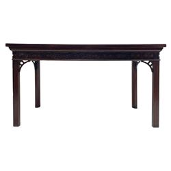 In the manner of Thomas Chippendale - early 19th century mahogany serving table, rectangular crossbanded top with boxwood stringing, the frieze with upper moulding over applied geometric fretwork, the left-hand side fitted with slide, on fluted square supports with inner chamfer 