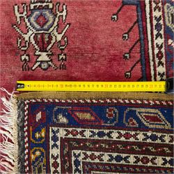 Persian Qashqai prayer rug, traditional tribal palette of red, indigo blue ivory and ochre, central field with stepped mihrab design in red, cantered by a stylized hanging lamp framed by a moss green spandrels, framed by boteh and floral motifs within multiple borders including an ivory border decorated with stylized animals in alternating colours 