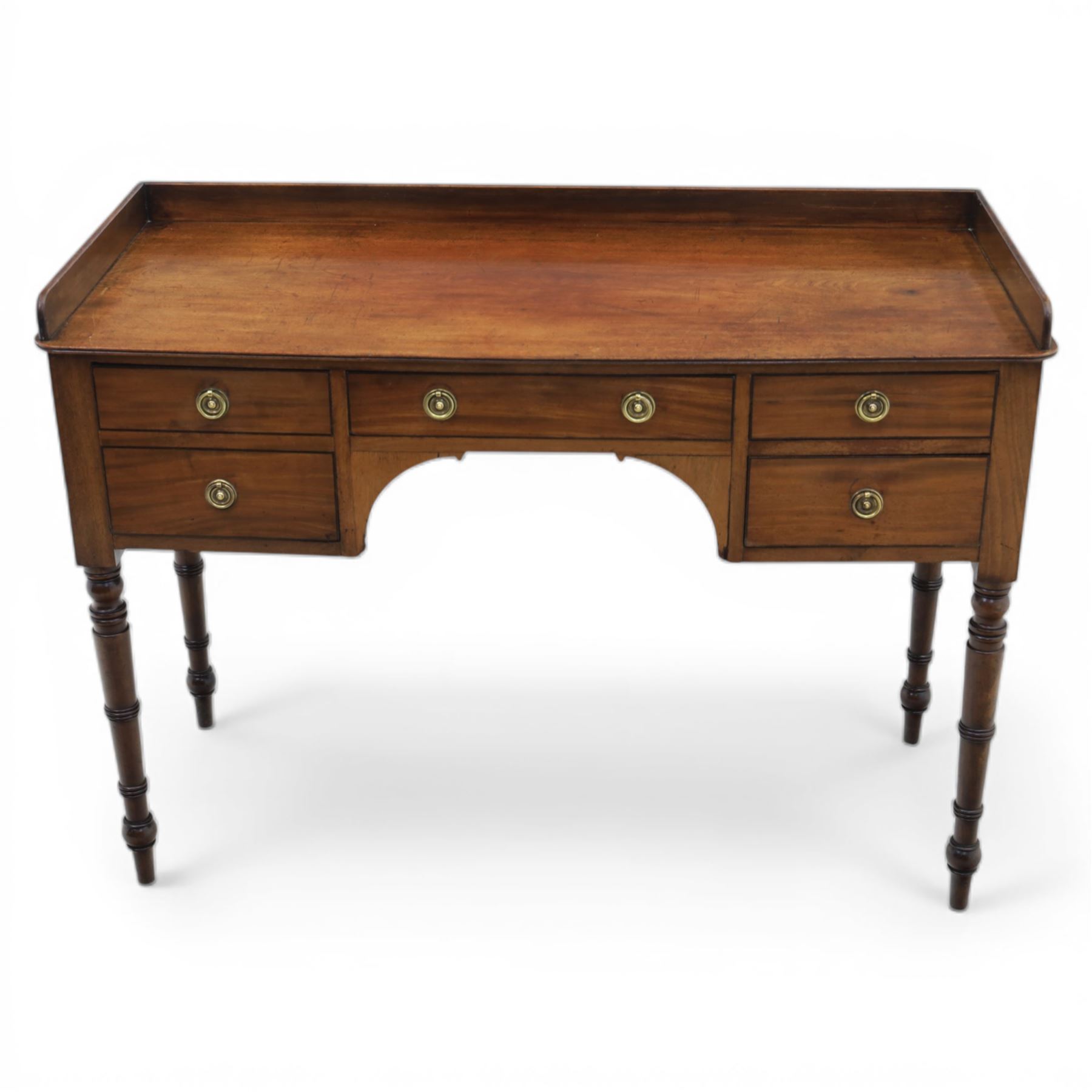 Late Georgian mahogany sideboard, circa 1820, the rectangular top with gallery, above an arrangement of four drawers with brass ring handles, one double height drawer to the left, a central single frieze drawer, and two drawers to the right, upon turned legs