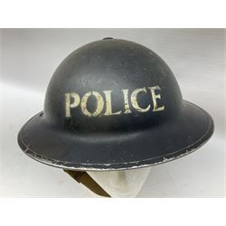 WW2 Home Front 'Police' black painted steel helmet with original liner and webbing chin strap, impressed R.O. Co. 1/1939; and re-painted shell only for WW2 Wardens steel helmet impressed AMC II 1941 C676 (2)