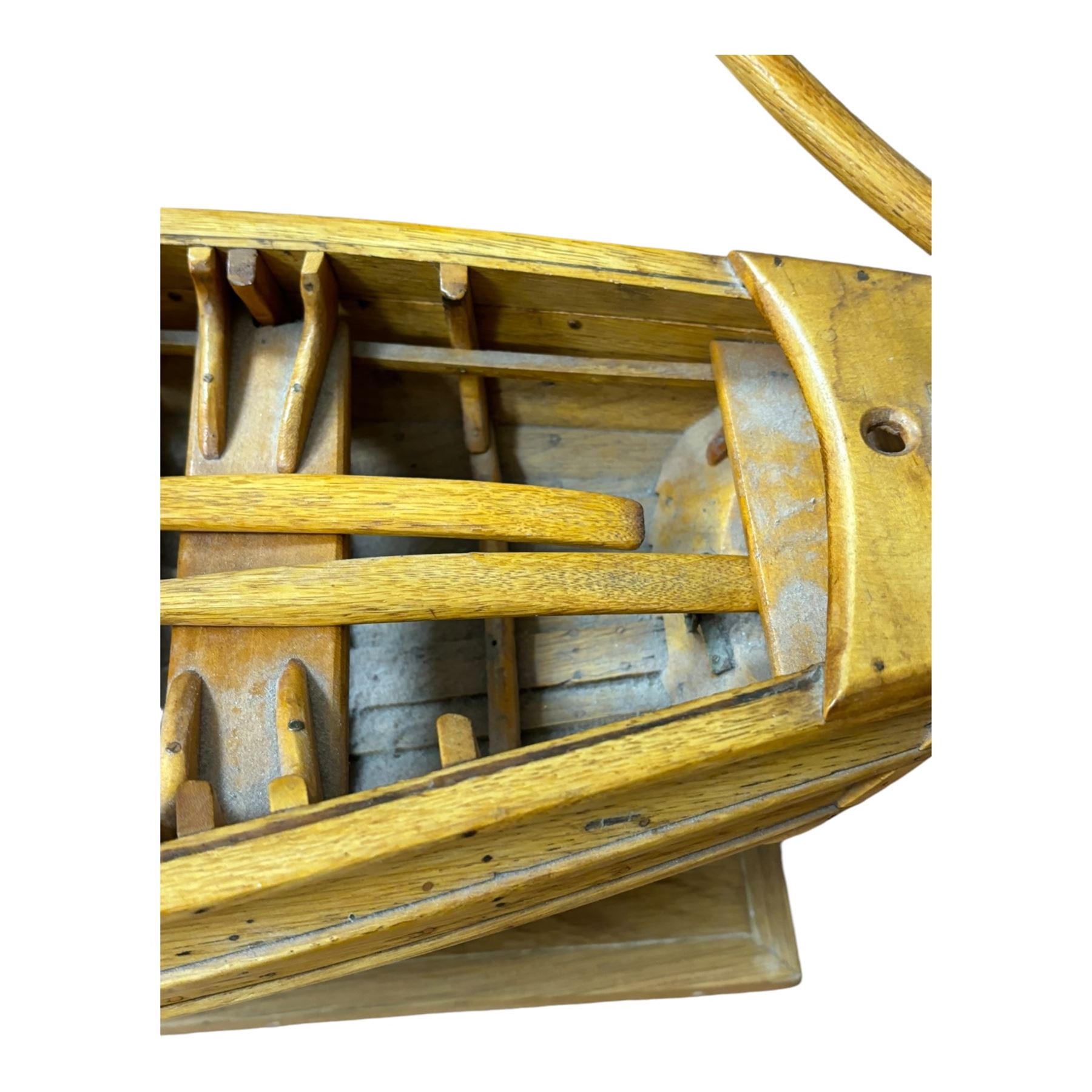 Wooden model of a fishing coble, with single canvas sail, upon a rectangular wooden plinth, total H74cm