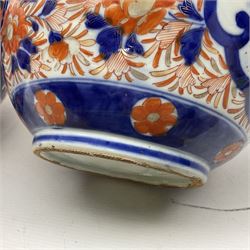 Pair of large 19th century Japanese Imari porcelain bottle vases, painted with shaped reserves of peonies, chrysanthemums and prunus blossom, each H46cm