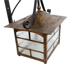 20th century, Arts and Crafts style copper porch lantern, of rectangular form, with cast iron scrolling wall fittings