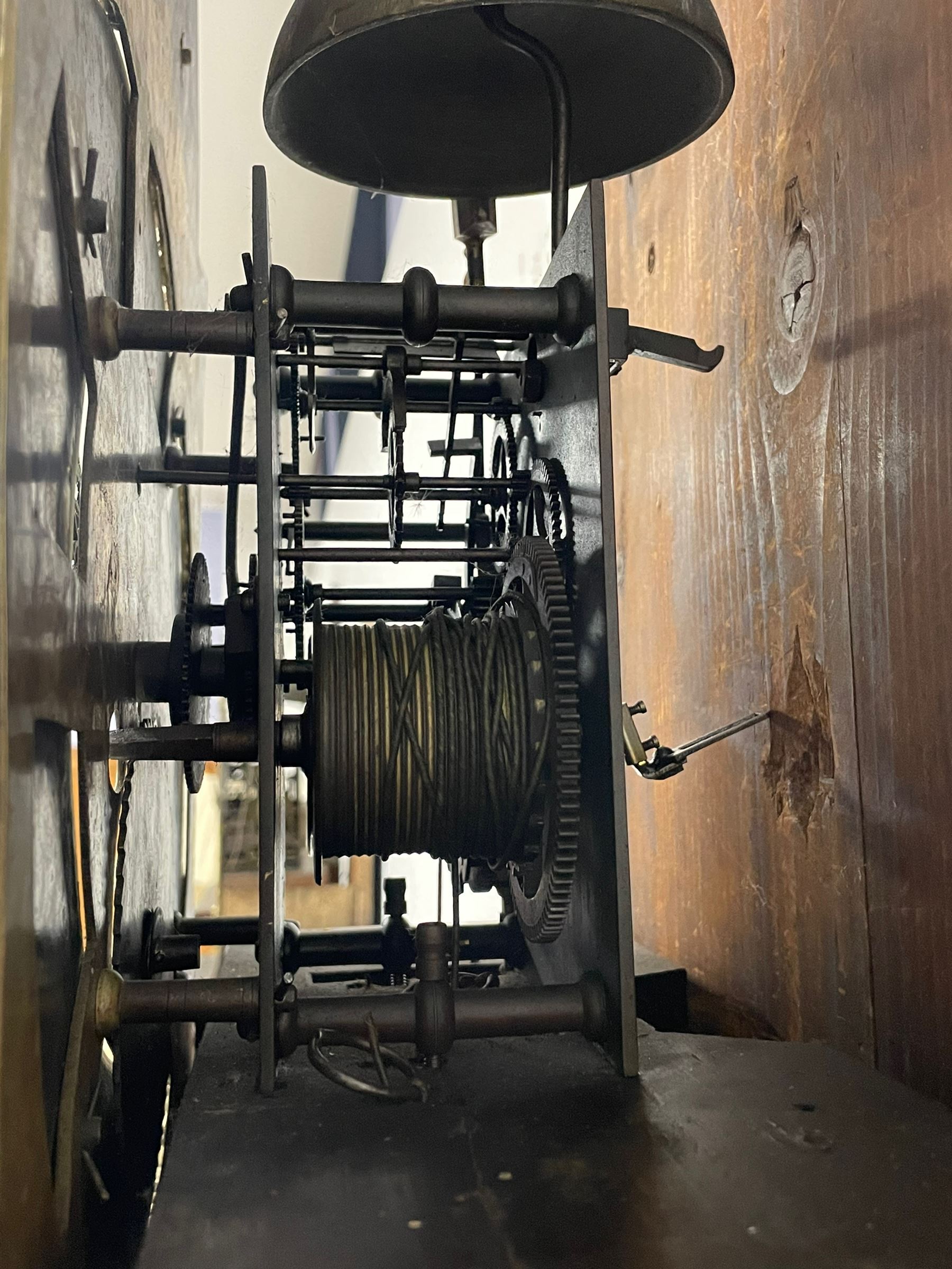 Thomas Hutchinson of Leeds - 18th century 8-day oak longcase clock with as broken arched  pediment and moulded cornice, with a conforming hood door flanked by plain turned pilasters with gesso capitals,  long trunk door with a wavy top on a square plinth with a raised panel, brass dial with cast spandrels,  engraved silvered dial centre and chapter ring with Roman numerals, five minute Arabic's and minute track, with pierced steel hands, seconds pointer,  arched calendar aperture and silvered boss engraved with the makers name to the break arch, dial pinned to a rack striking two train movement with a recoil anchor escapement. With weights and pendulum. Thomas Hutchinson is recorded as working in Leeds from 1760-90.