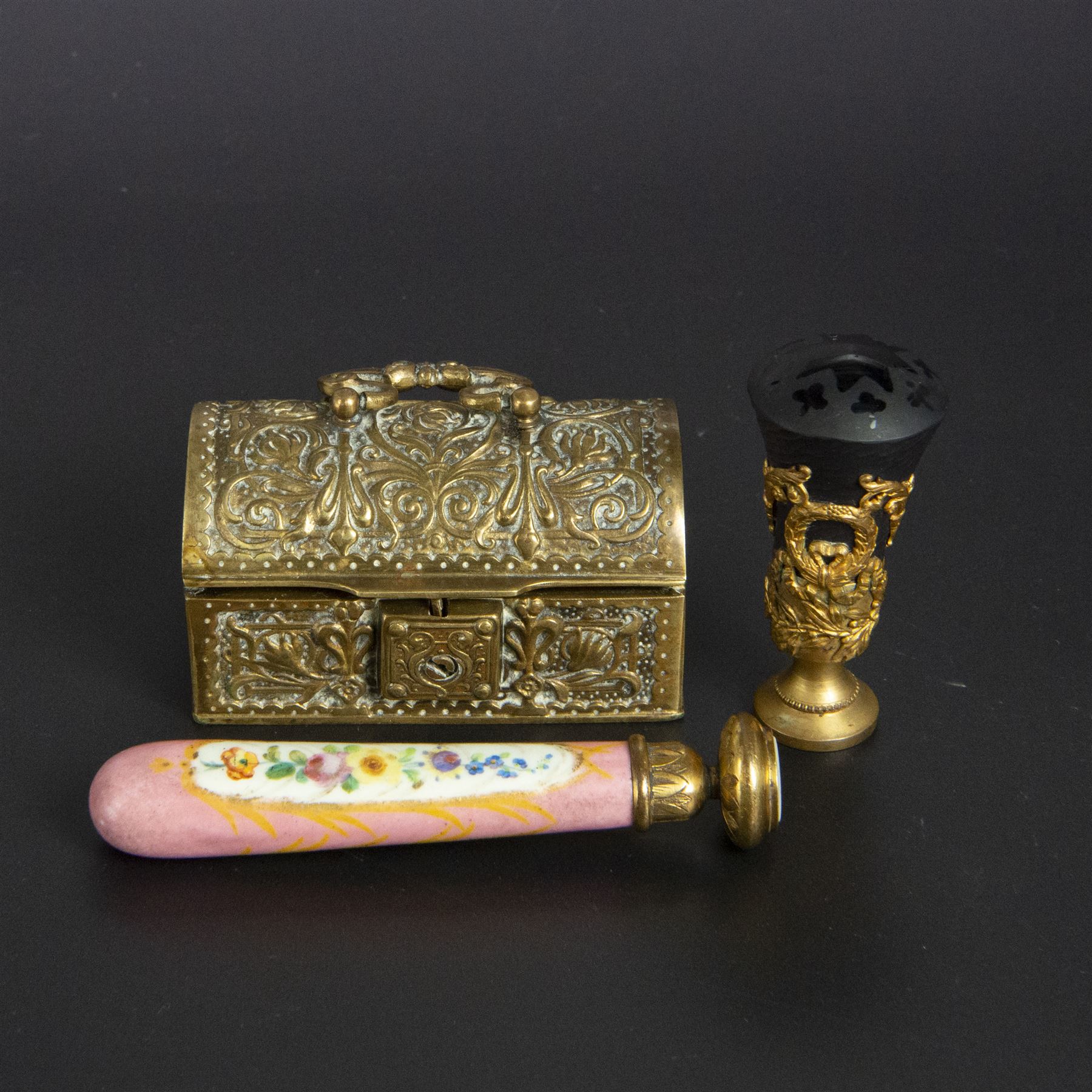 Gilt bronze mounted black glass seal, contained within a brass casket, with velvet interior and inner label reading 'C. F. Schmedding Augsburg', together with a porcelain handled seal decorated with floral sprays on a pink ground