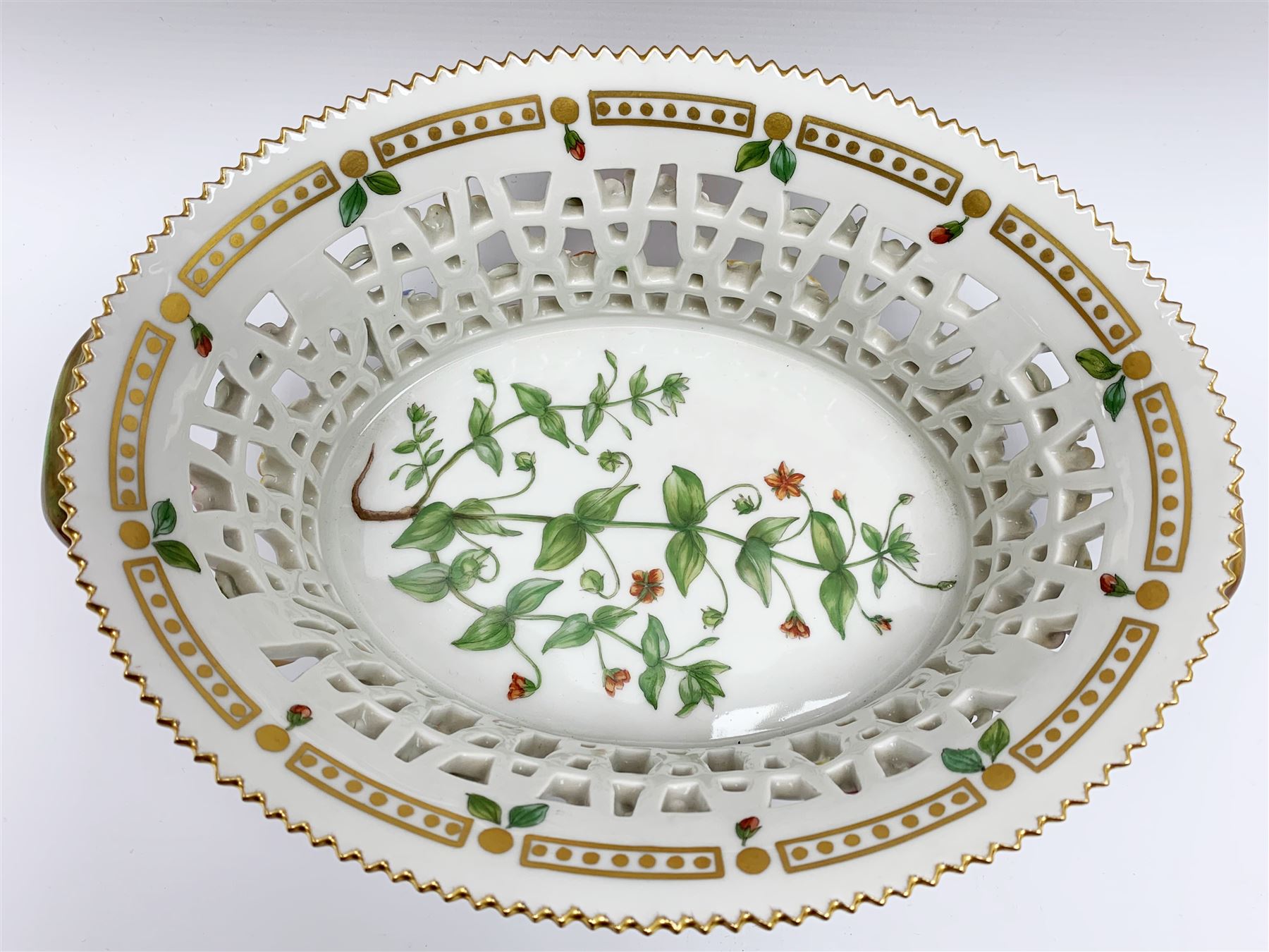 Royal Copenhagen Flora Danica basket, with naturalistically modelled vine handles and reticulated sides detailed with polychrome forget-me-nots, the interior decorated with a botanical study of 'Anagallis arvensis', sprigs and a gilt border, with printed and painted marks beneath, H8cm L26cm 

