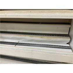 Six shelved cabinets for displaying ‘00’ gauge locomotives comprising plain plywood and white painted examples with track applied to various shelves, largest H63cm, W107cm, D27cm; Collection of tools for building model locomotives to include Weller PU-2D Soldering Pencil and Standard Tip Soldering Iron 20W/230V, Humbrol Modellers Airbrush, Power Supply Units and two wooden chests one of which housing a collection of tools including tweezers, scalping tools, wrenches etc 