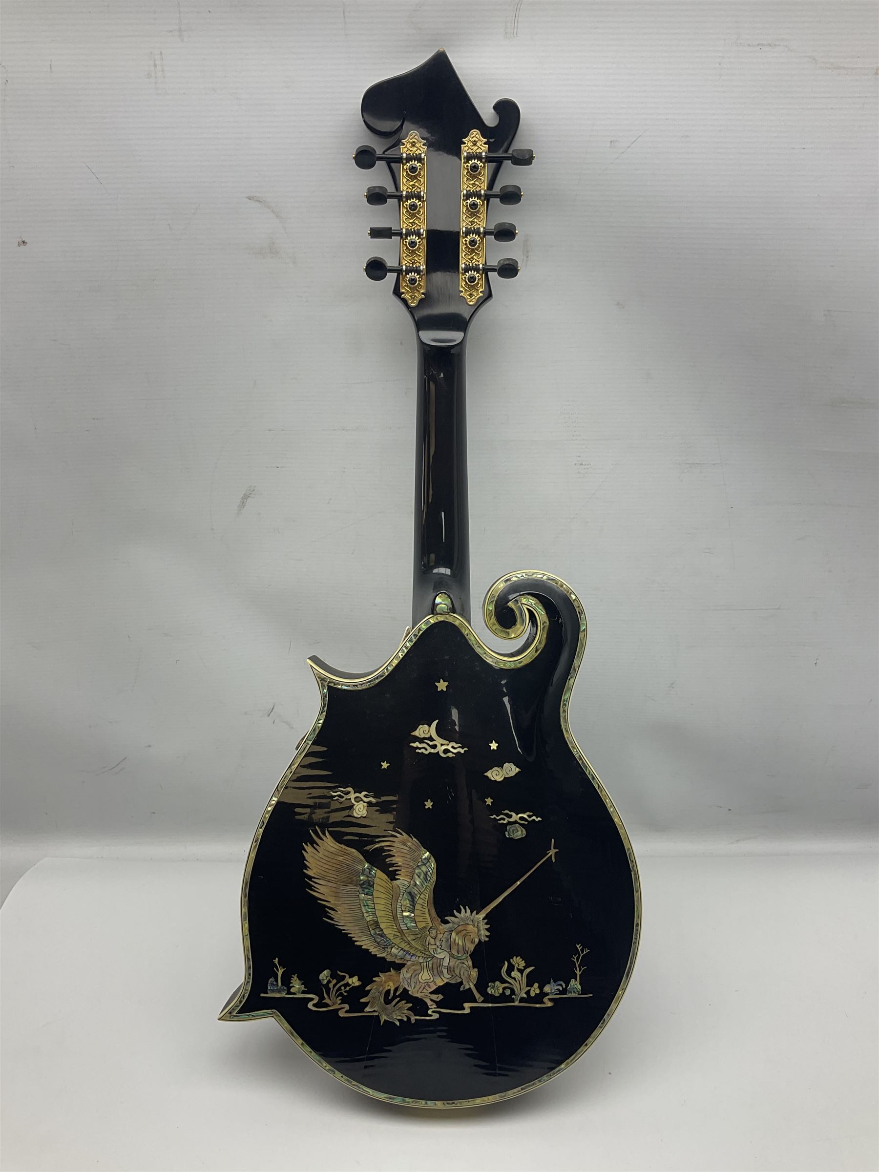 Eastern F-hole eight-string mandolin with black finish and mother-of-pearl inlay of a man riding a winged horse/unicorn amongst clouds and stars with playing card suits to the fingerboard L71cm