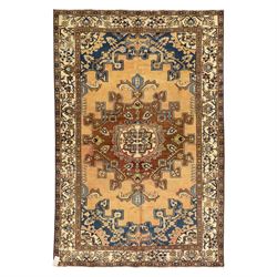 North West Persian Tafresh hand-knotted rug, pale apricot field with central stepped medal...