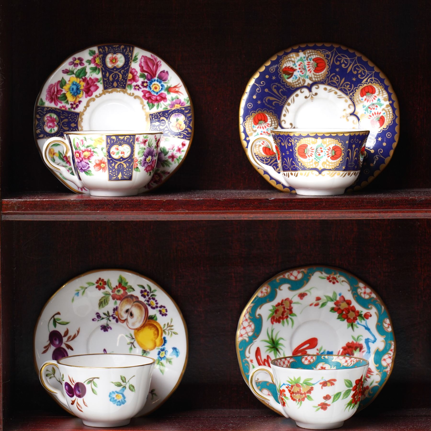 Royal Worcester miniature cups & saucers collection, 1993,  various patterns on display shelf, with certificates, shelf H49cm