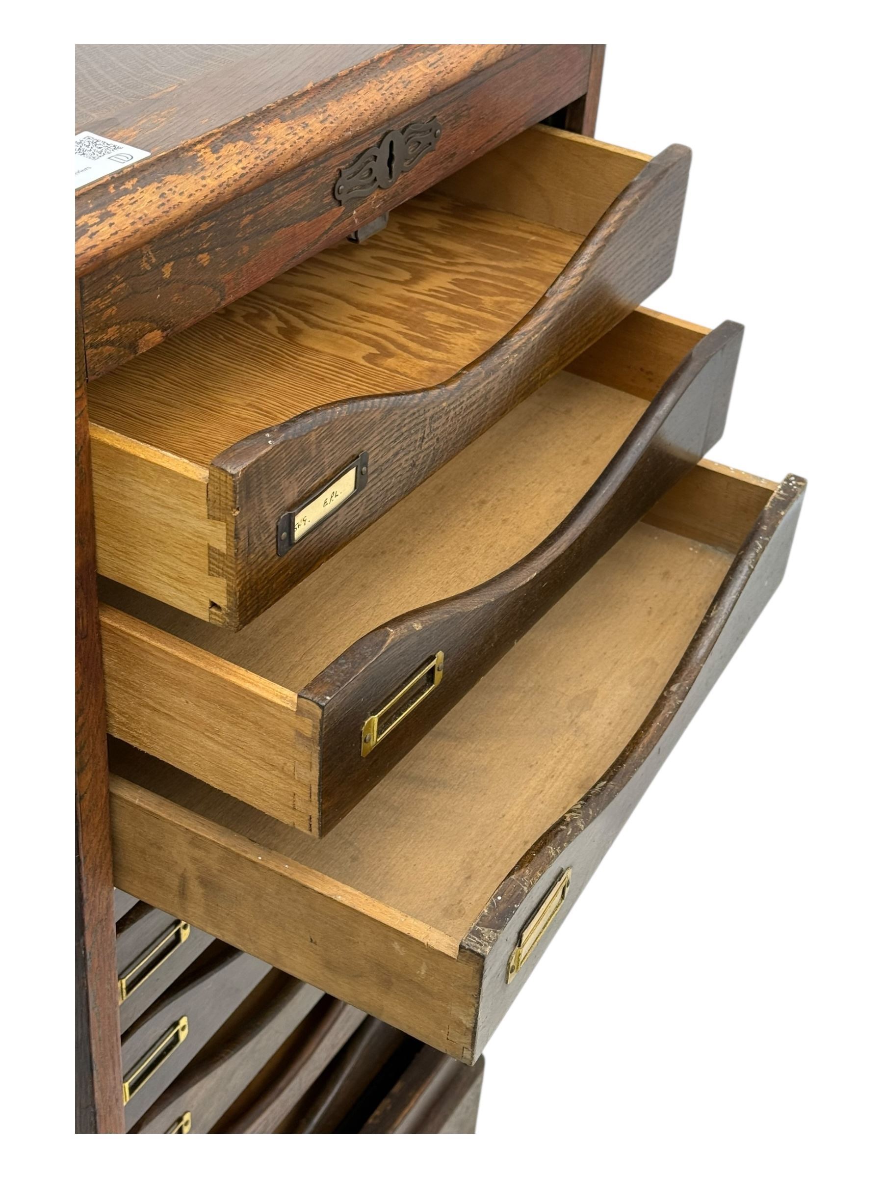 Two early 20th century mahogany tambour cabinets, each with retractable roll-top front revealing fitted interior with concave-front filing drawers and brass fittings