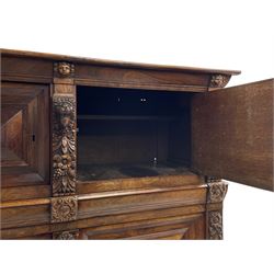 Late 17th century Flemish/Dutch rosewood and oak ‘Zeeuwse Kast’ or cupboard, projecting cornice carved with three putti masks, the uprights carved with lion masks over ribbons, flower heads and foliage, enclosed by four geometric panelled doors, lower central upright carved with flower head over foliate ribbon with bird among foliage, the escutcheon hidden by swivel berry carved cover, interior fitted with shelves, two drawers and shallow hinged cupboard, on two large turned and ebonised feet, circa 1680