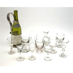 A silver plated wine bottle holder, together with a selection of glassware, to include a Victorian gill measure with lead seal stamped VR, two Victorian rummers, and other 19th century and later drinking glasses. 