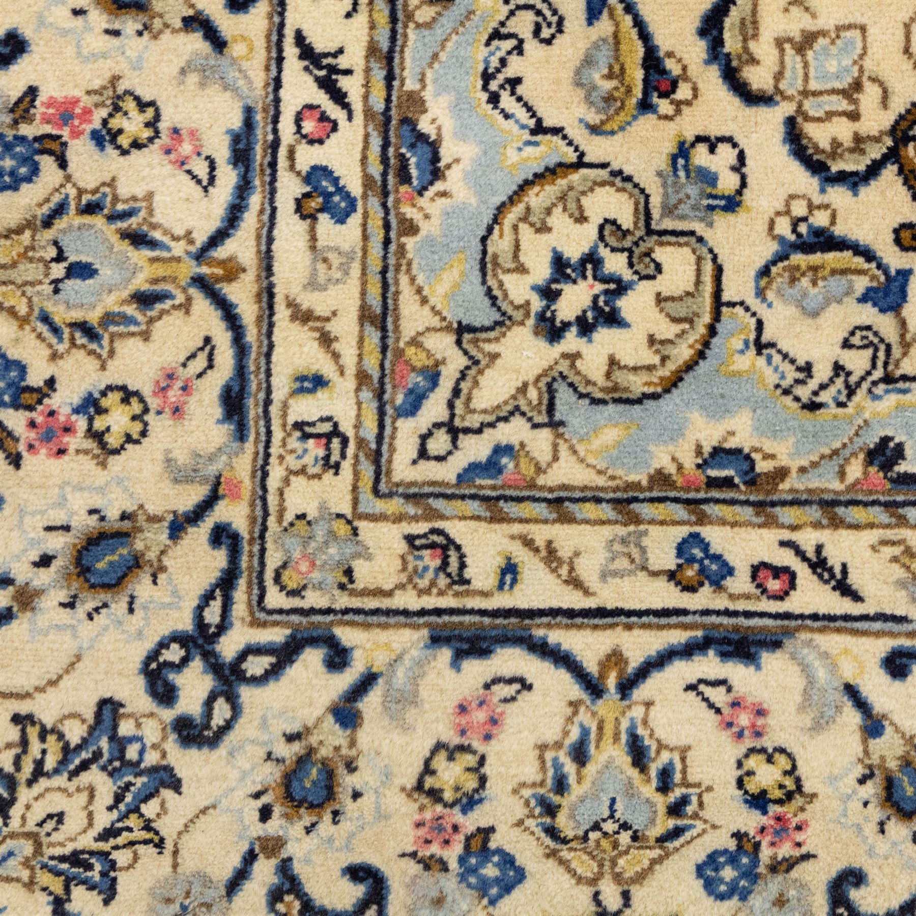 Central Persian Kashan hand-knotted carpet, ivory ground, with a central pale blue shaped floral medallion with pendants, surrounded by scrolling foliate and floral motifs incorporating rosettes, palmettes and delicate vine work in blue, cream and beige tones, enclosed by an ivory border with repeating palmettes and meandering vines, flanked by floral guard stripes, with cotton fringes