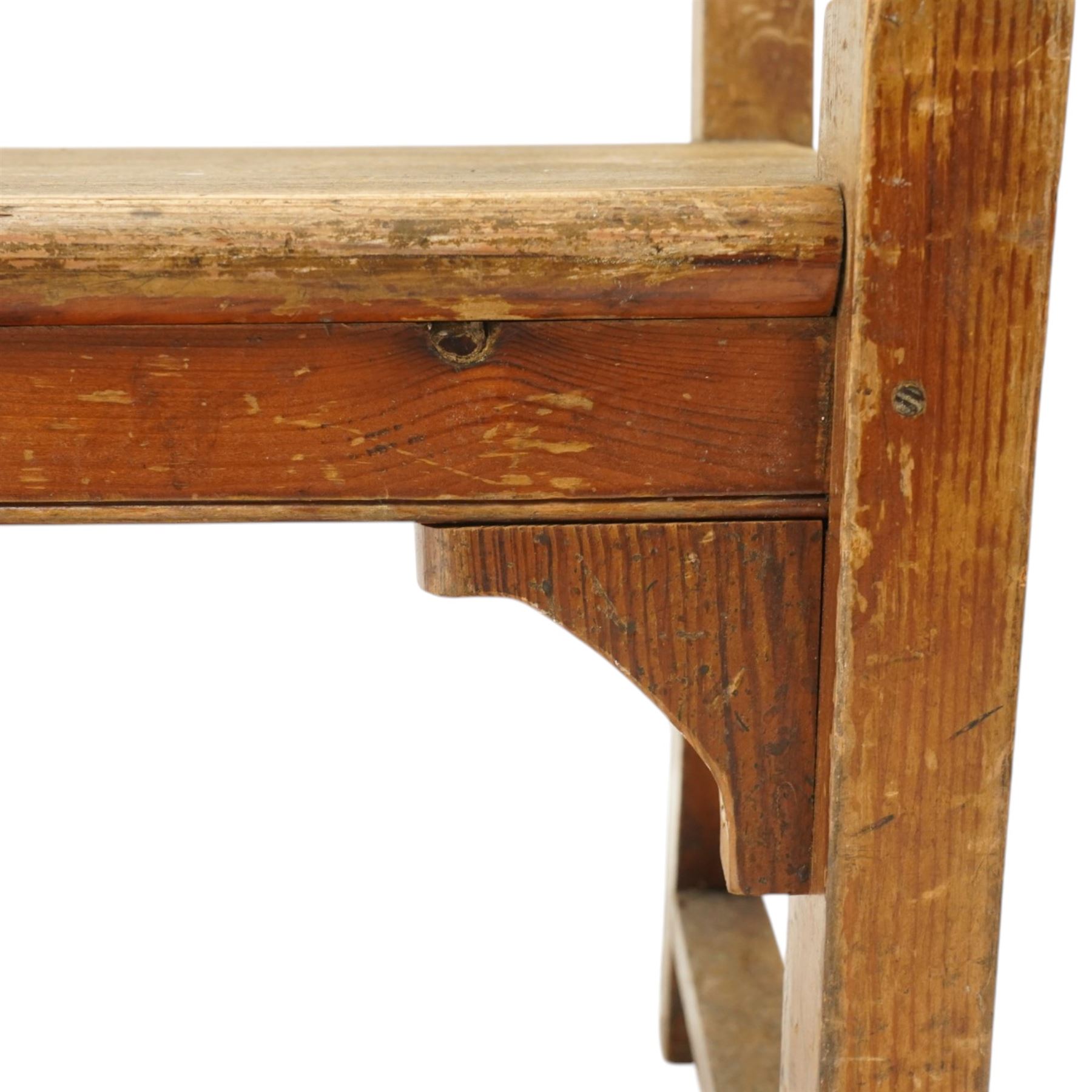 Early 20th century pine chapel bench, with moulded plank back rail over plain rail, with book storage to the back, open shaped end supports with curved arms, turned front uprights, plank seats, square legs united by low stretchers