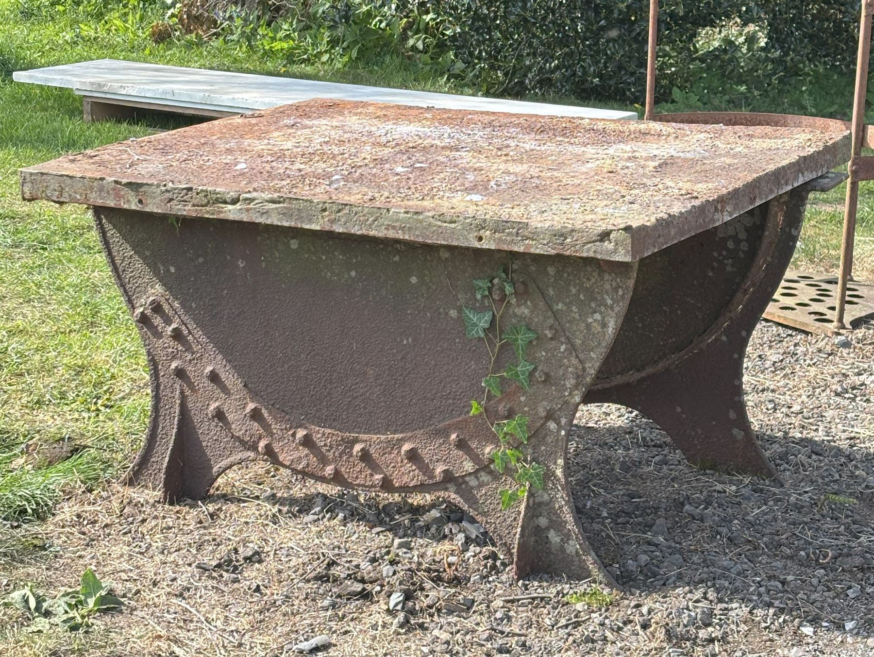 Cast iron garden table, repurposed from a grindstone base with associated iron top. H64cm, 91cm x 116cm.  - COLLECTION BY APPOINTMENT FROM: The White House, Thirsk Road, Easingwold, York, YO61 3NF - CALL 01723 507111 TO ARRANGE