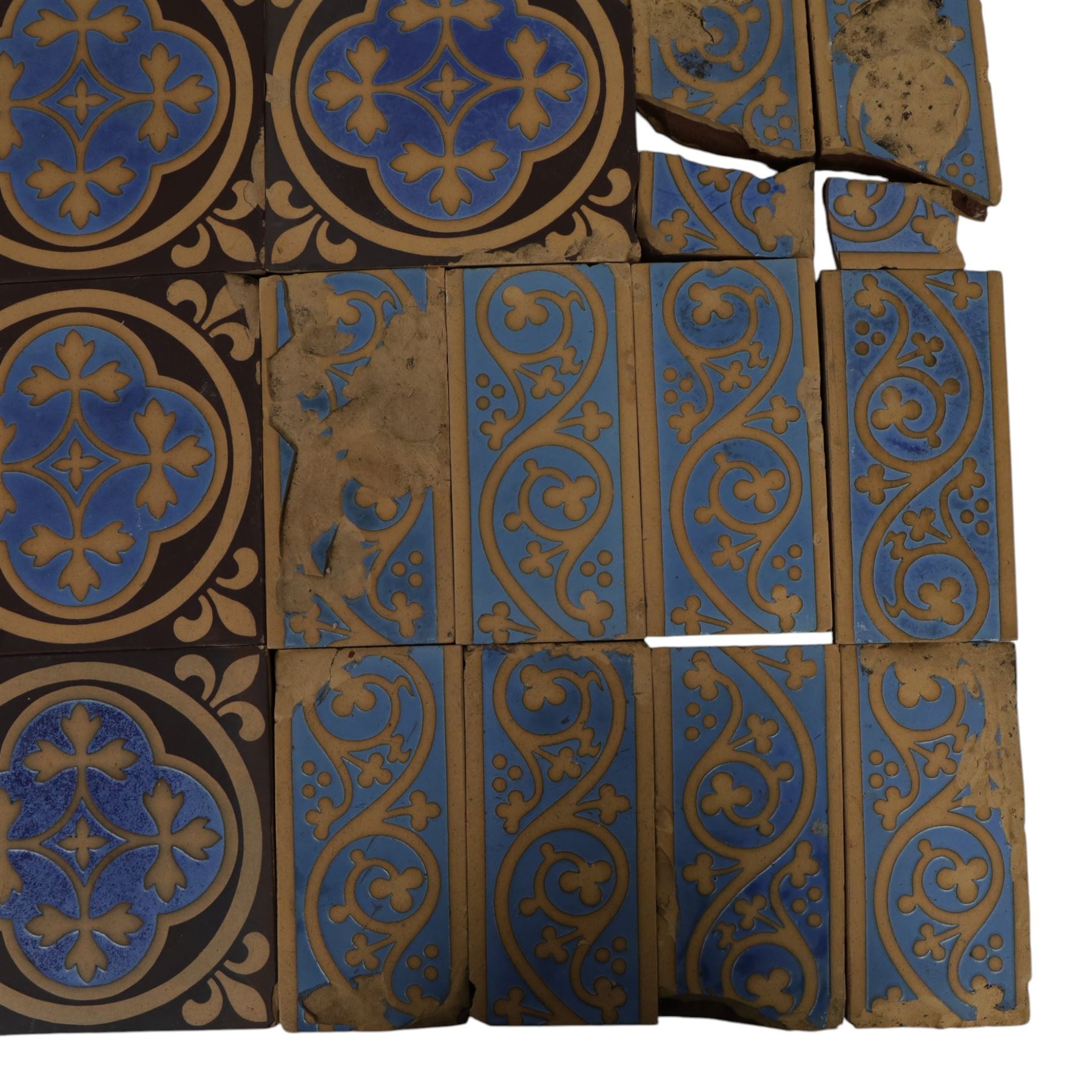Minton & Co, Gothic Revival polychrome encaustic floor tiles, circa 1850, including six decorated with a central cardinal quatrefoil upon a blue ground, boarder tiles with scrolling vines and similar