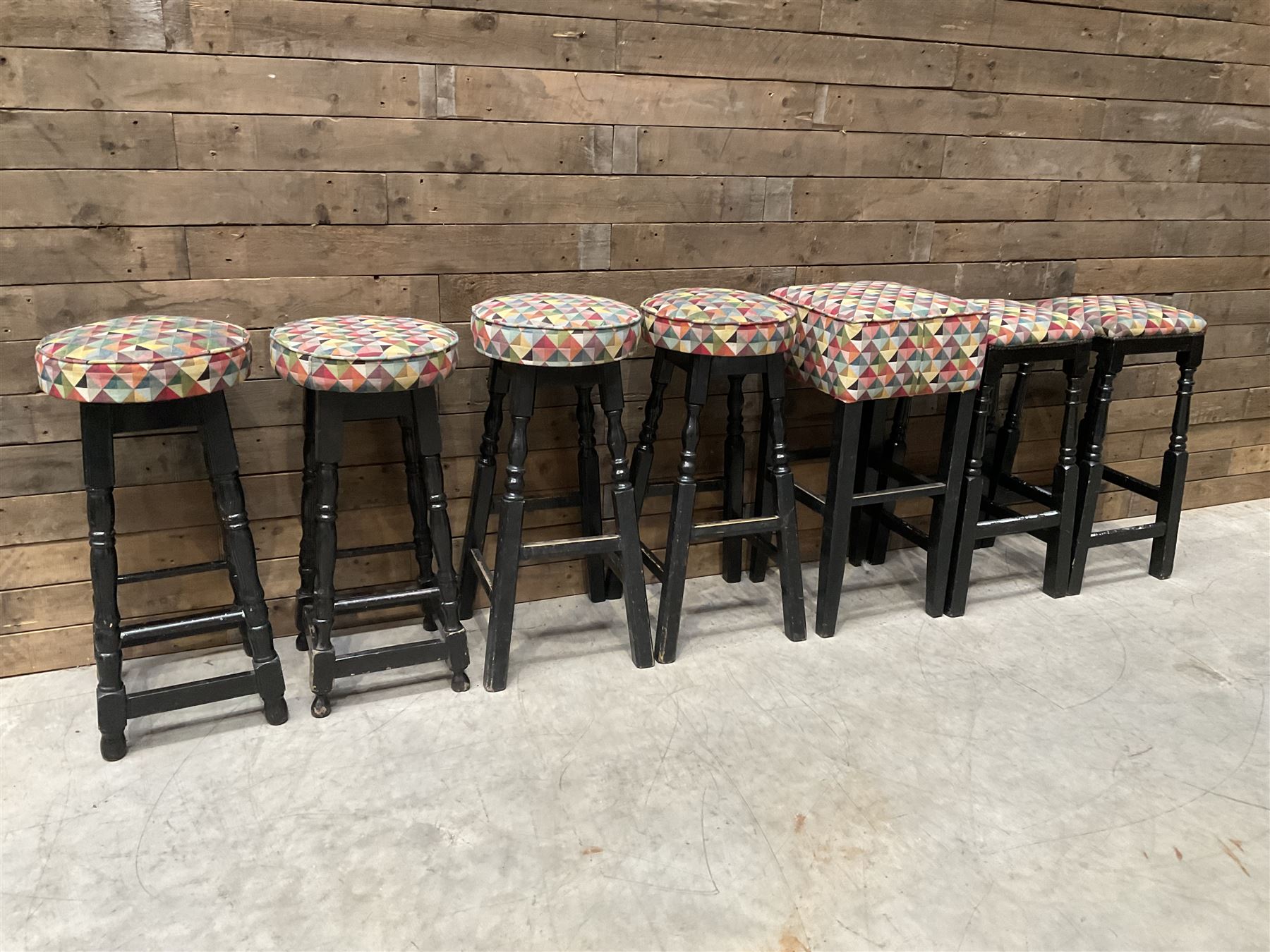 Seven tall bar stools with upholstered seat
