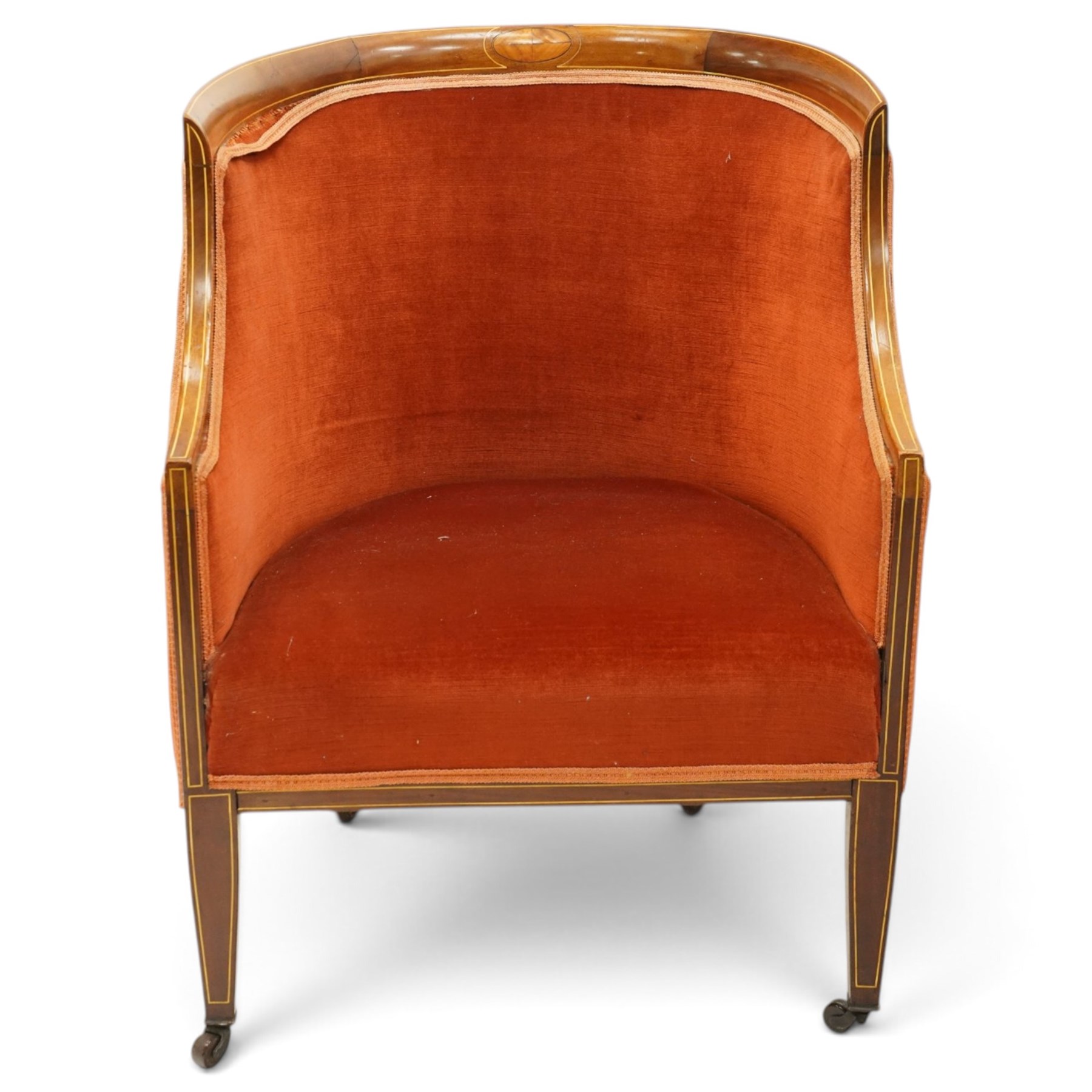 Pair of Edwardian inlaid mahogany tub armchairs, traditional shape with satinwood stringing, upholstered in crimson fabric with sprung seat, on square tapering supports with castors