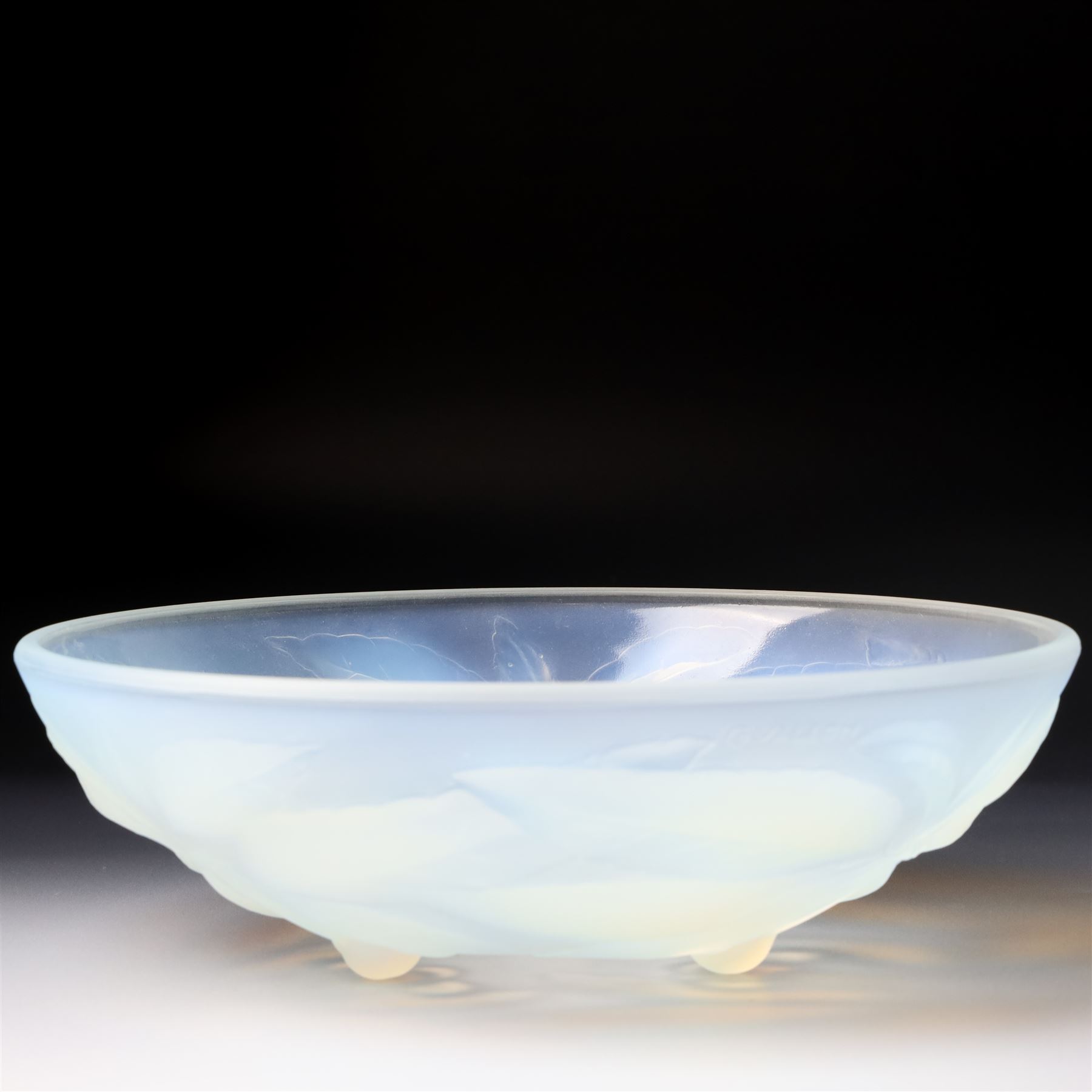 G Vallon, a French opalescent glass bowl decorated with a raised pattern of cherries and leaves signed G Vallon D23cm