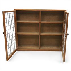 Rustic pine cupboard fitted with wire panelled doors, enclosing staggered adjustable shelving