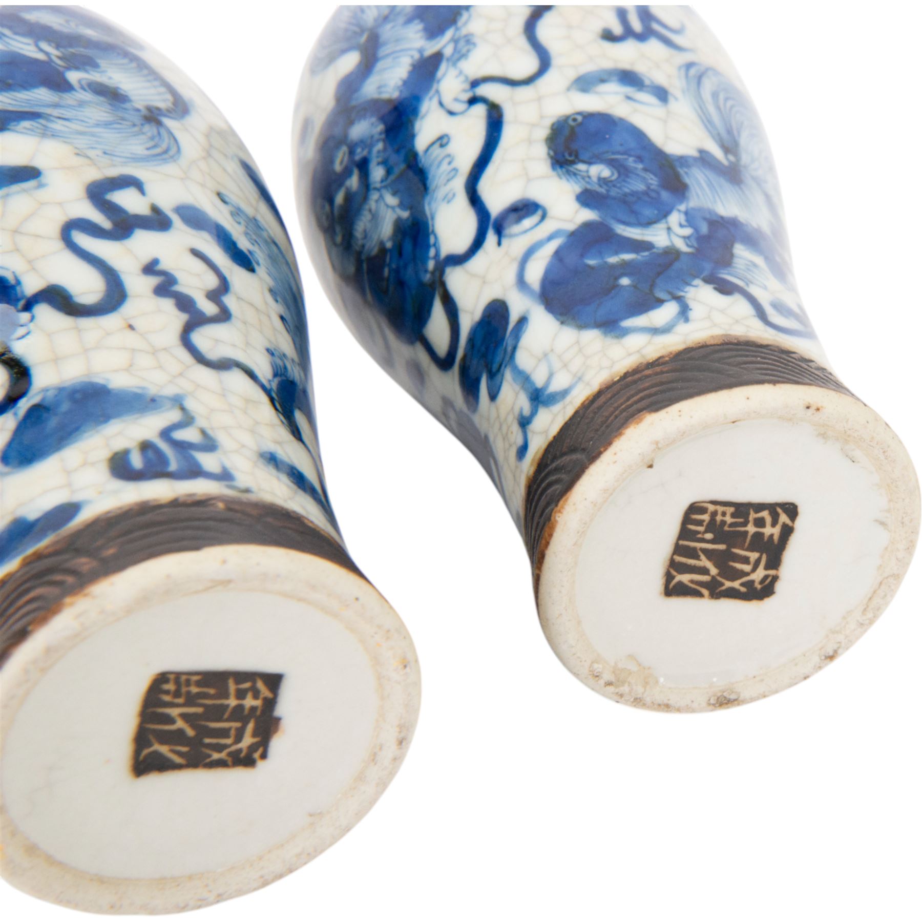 Pair of 20th century Chinese crackle glaze vases, of baluster form, decorated with dogs of foo amongst clouds, H23cm