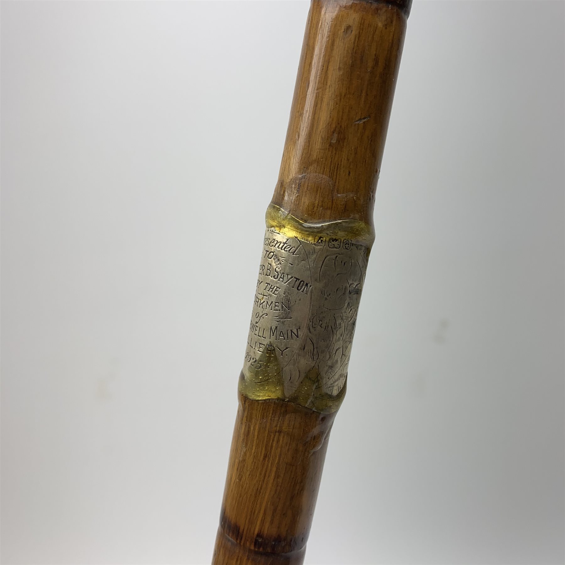 Three silver mounted walking canes, the first hallmarked Kendall & Sons Ltd, London, date letter worn and indistinct, the second hallmarked Birmingham 1924, maker's mark C&S, the third marked Sterling Silver, C&S. 