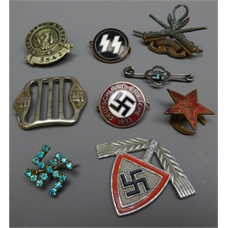  German SS Members Lapel Badge, makers marks 'RZM' M1/4 Ges. Gesch, National Socialist Party enamel Badge, marked RZM M1/129. Peech & Tozer lapel Badge, RAD Cap Badge, German buckle stamped 41949, South African Heavy Artillery Cap Badge, two Swastika brooches and a Hammer & Sickle lapel badge, (9)  