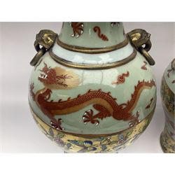 Pair of early 20th century Chinese vases decorated with dragons chasing a flaming pearl, with a gilt border of butterflies and floral sprigs, with Elephant head handles, H44cm 