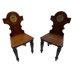 Set of four 19th century mahogany hall chairs, the shaped back with circular naval crest, applied moulded frame with scrolled terminals, canted moulded seat on square tapering supports with recessed panels, decorated with geometric rectangular and circular mounts