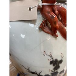 Chinese Republic period porcelain moon flask vase, of typical compressed spherical form, the neck and shoulders with applied iron red dragon handles, the body decorated in iron-red and grisaille with a 'one hundred children' design, depicting various children at play and engaged in musical pursuits within a garden setting, with apocryphal Qianlong mark beneath, H47cm