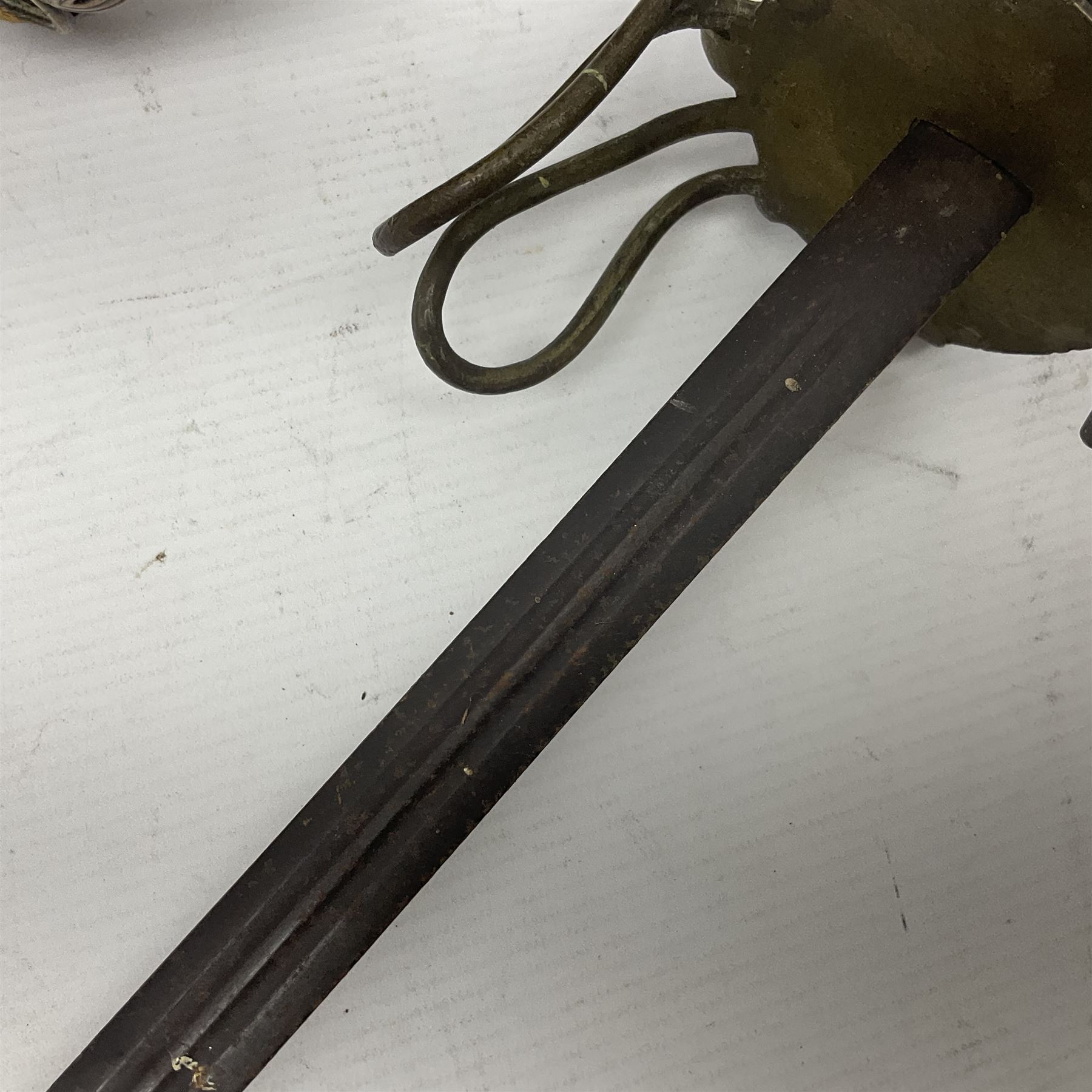 Victorian 1845 pattern infantry officer's sword the 82cm sharpened fullered steel blade with traces of decoration, brass gothic hilt incorporating Victorian cypher, folding back guard, stepped pommel with acanthus leaf backstrap and wire-bound wooden grip with traces of original fish skin covering L96cm overall; together with a reproduction Scottish style basket hilted sword; both lacking scabbard (2)