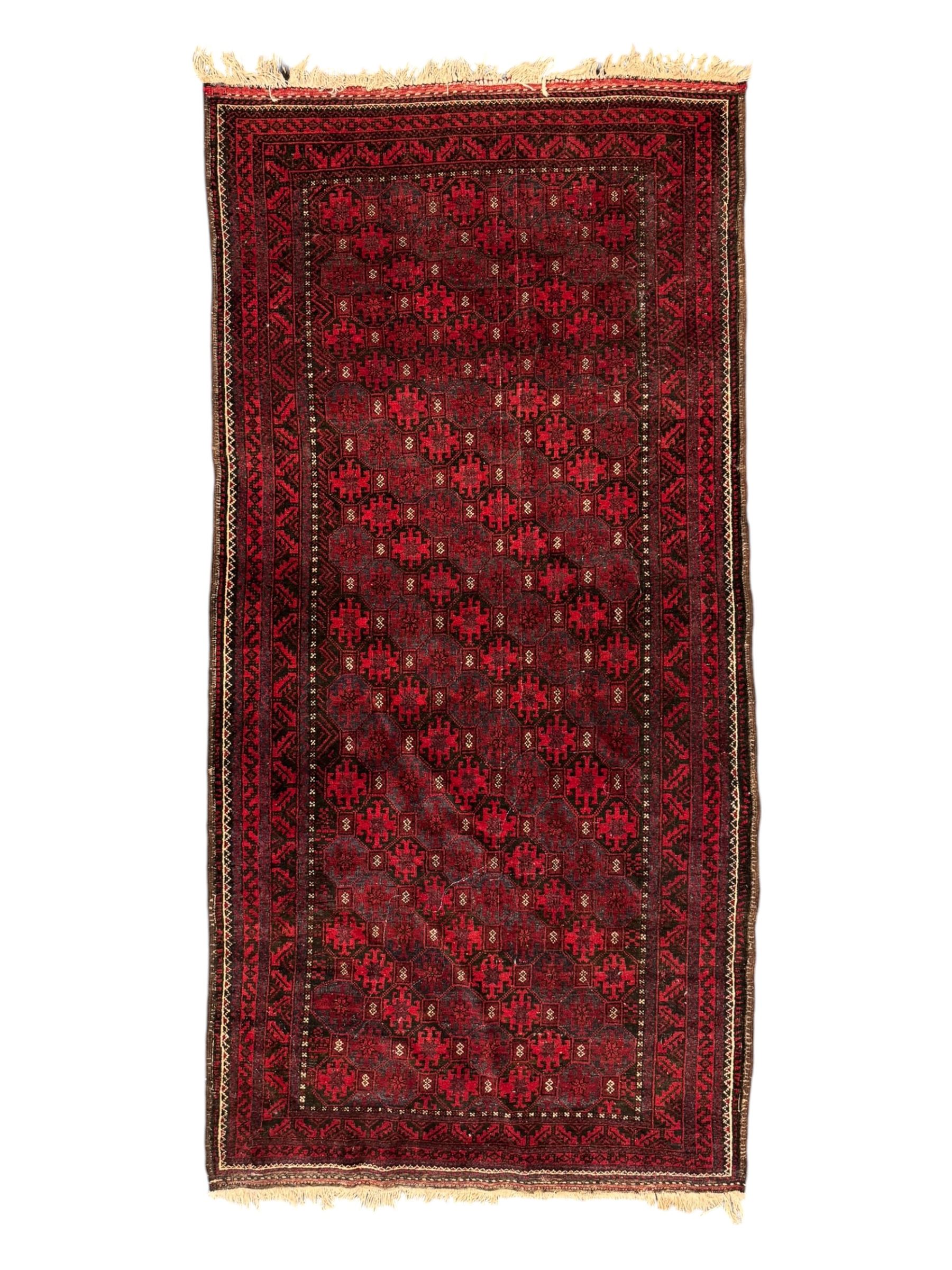 Turkoman red ground wool rug, the field with a repeating pattern of Tekke gul motifs in dark brown and red (195cm x 98cm); Afghan Bokhara red ground wool rug, central field with repeated geometric octagonal gul motifs, surrounded by multiple borders with stylised diamond and triangular patterns (127cm x 181cm)
