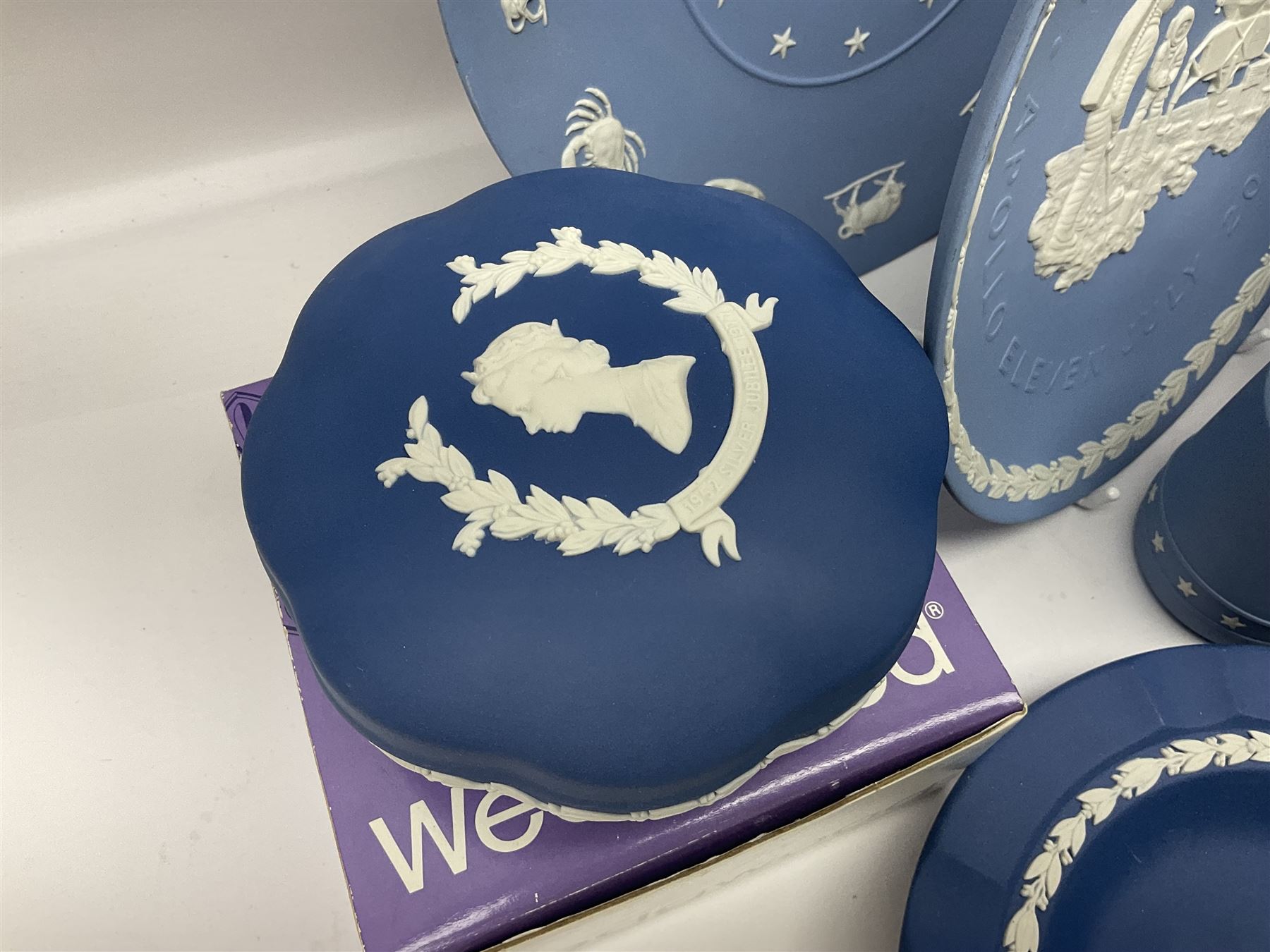 Collection of Wedgwood Jasperware, to include black Eisenhower Bust, two black basalt paperweights, one depicting an eagle and one depicting Julius Caesar, a blue Zodiac plate, Man on the Moon commemorative plate, American Independence Bicentennial plate and Royal commemorative ware, etc, all with impressed marks beneath, some with boxes