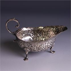 Victorian silver sauceboat, of typical form with embossed floral and foliate decoration, hallmarked London 1886, together with a miniature silver trophy and silver pickle fork, both hallmarked, trophy H7.5cm