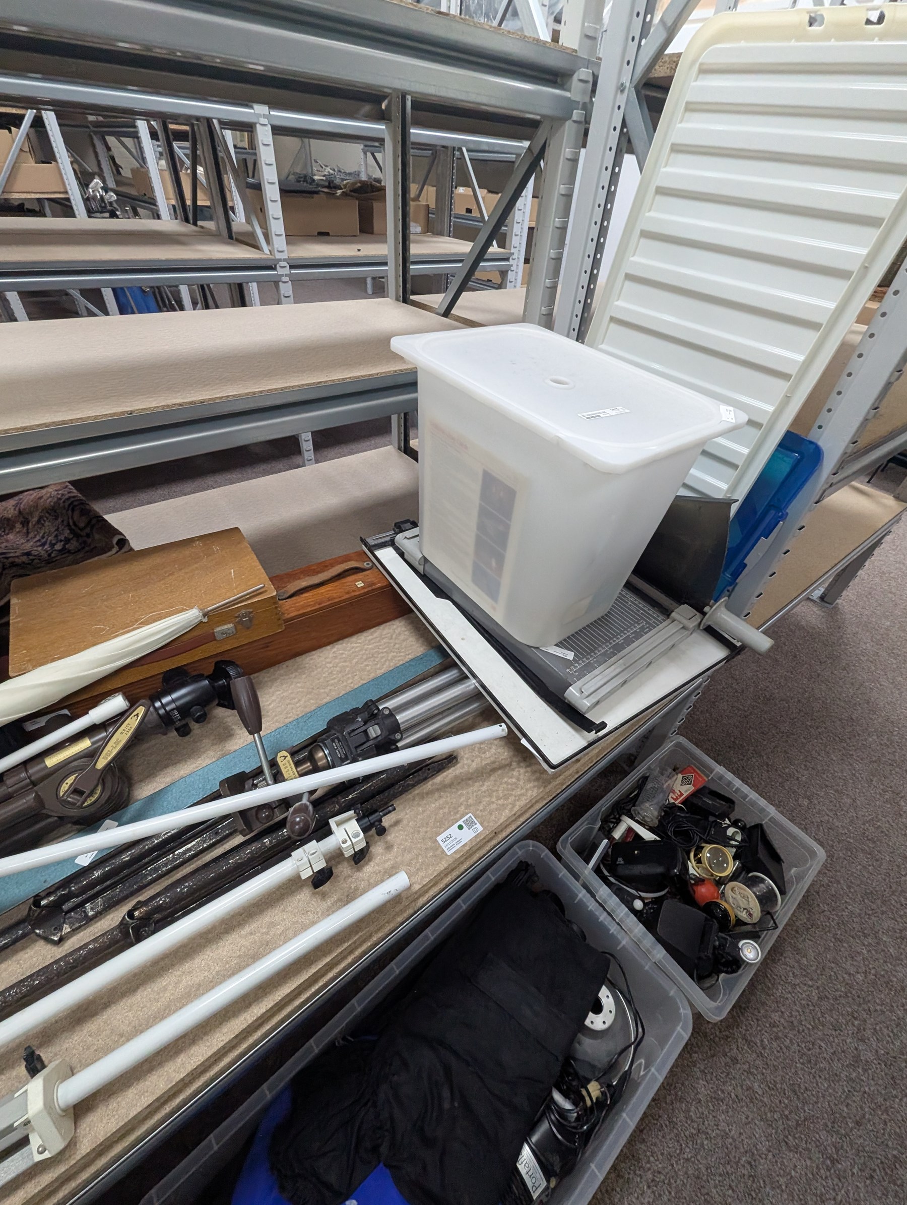 Collection of photography equipment, including cases, tripods, screens, guillotine, lighting etc