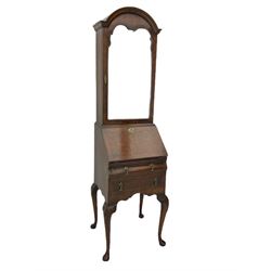 Small early 20th century Queen Anne style bookcase on bureau secretaire, the moulded arched pediment over mirrored door in shaped frame, the bureau fitted with fall front enclosing curved fitted interior, cushion moulded drawer over single drawer, on scroll and shell carved cabriole supports