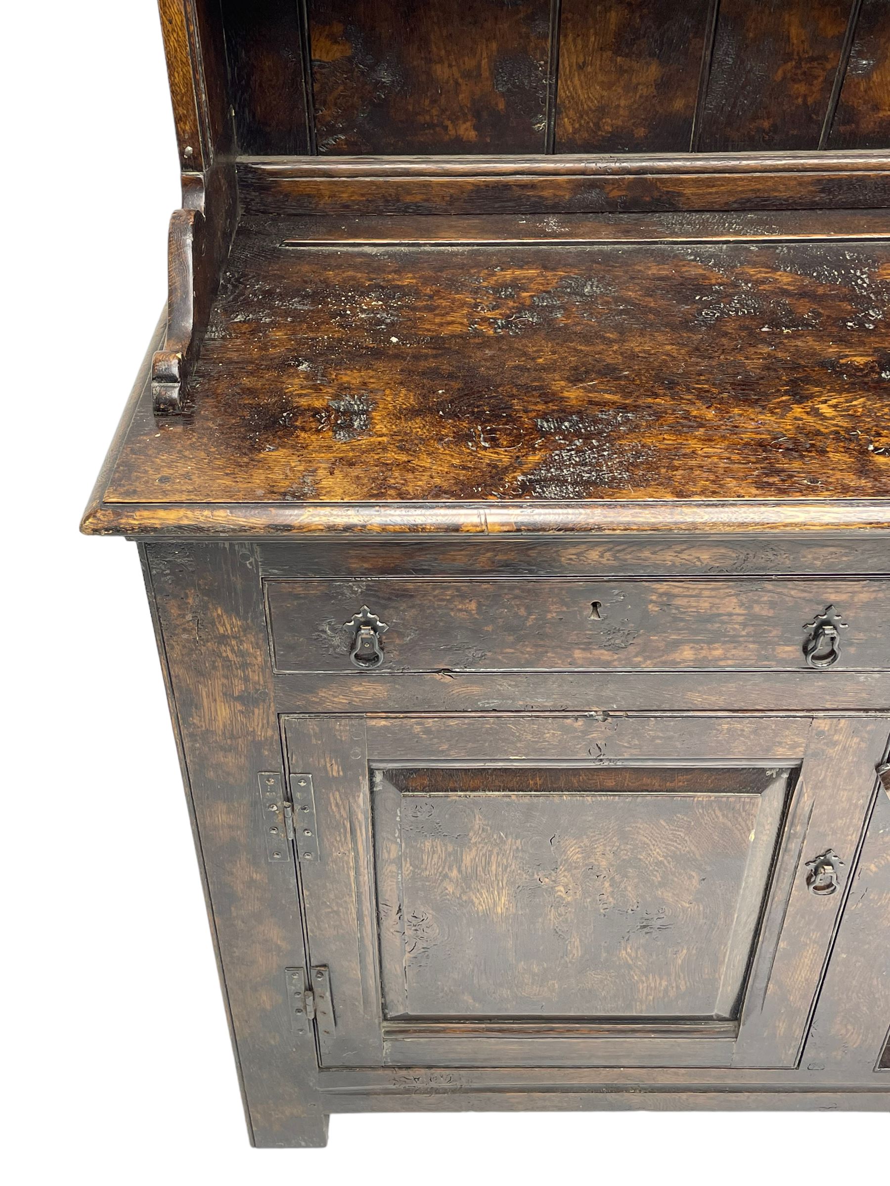 Bylaws of Leominster - 18th century design figured oak dog kennel dresser, the raised plate rack with projecting cornice over hooks and three tiers, moulded rectangular top over three drawers and two panelled cupboards, moulded frame and panelled sides, on stile supports