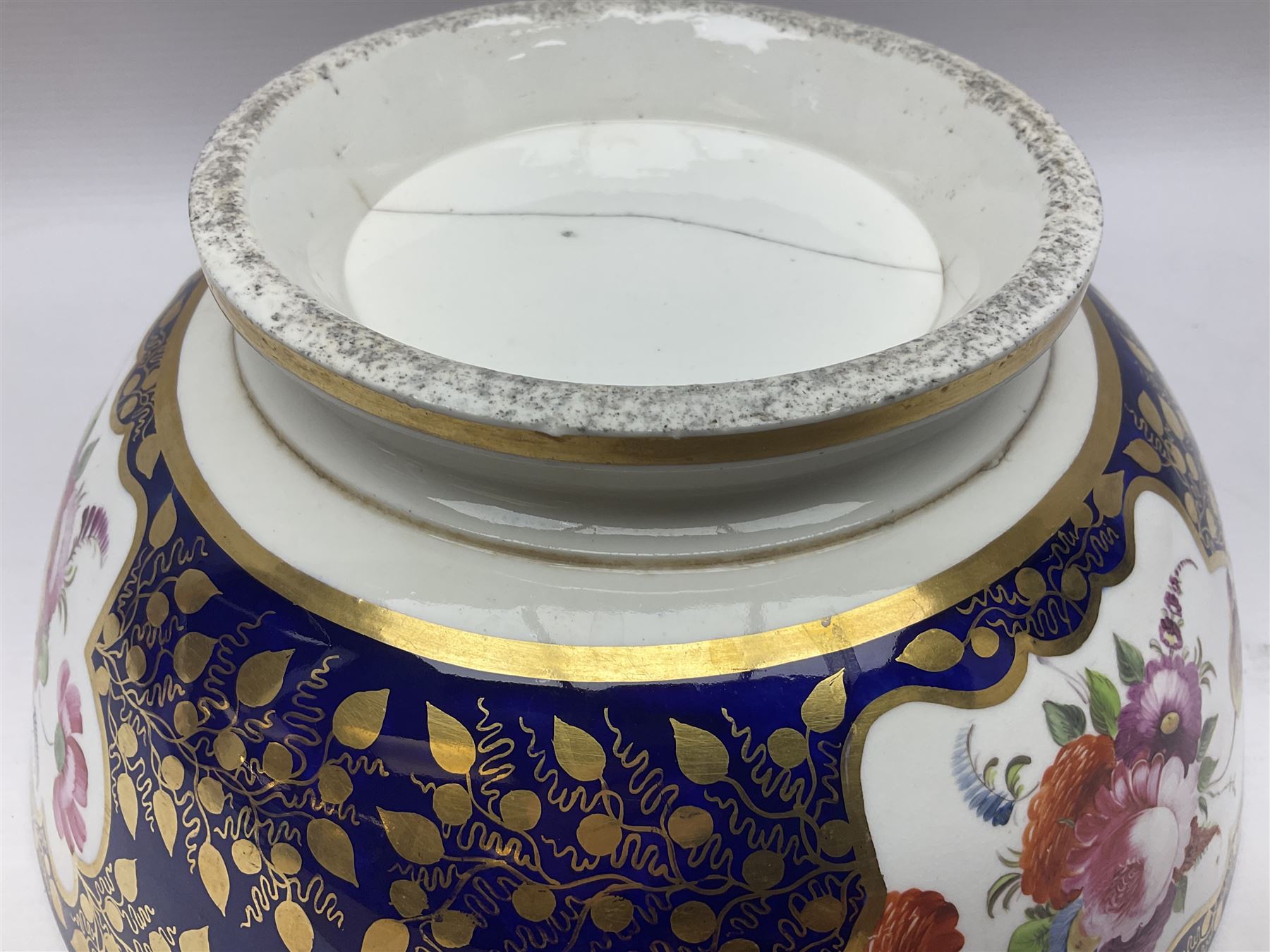 19th century continental bowl, decorated with hand painted floral sprays amongst gilt foliate decoration on a cobalt blue ground, D27.5cm