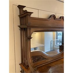 Late 19th century Arts & Crafts period oak mirror back sideboard, shaped bevelled mirror back carved with foliate scrolls and flower heads, down swept supports with elongated club-shaped uprights, moulded rectangular top over two drawers and three cupboards, the drawer fronts with copper handles decorated with sailing ships, panelled doors carved with mythical beasts, flowerheads and foliage, on moulded block feet