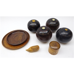  Four lignum vitae bowling balls, turned treen jar and cover, treen clog shaped snuff box and two 19th century turned mahogany plates (8)  