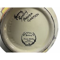 Lorna Bailey Old Ellgreave Pottery, comprising teapot in beach design, circular jar in house and path design, shell jug in Bridge and stream design, squat jug in Pagoda design and plate decorated with an Art Deco woman, all with printed and painted marks. 