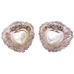 Pair of Victorian silver bonbon dishes, each of heart shaped form with pierced sides and C scroll and flower head rim, upon three ball feet, hallmarked William Henry Leather, Birmingham 1895, contained within a fitted case with blue velvet and silk lined interior, approximate silver weight 2.45 ozt (76.5 grams)