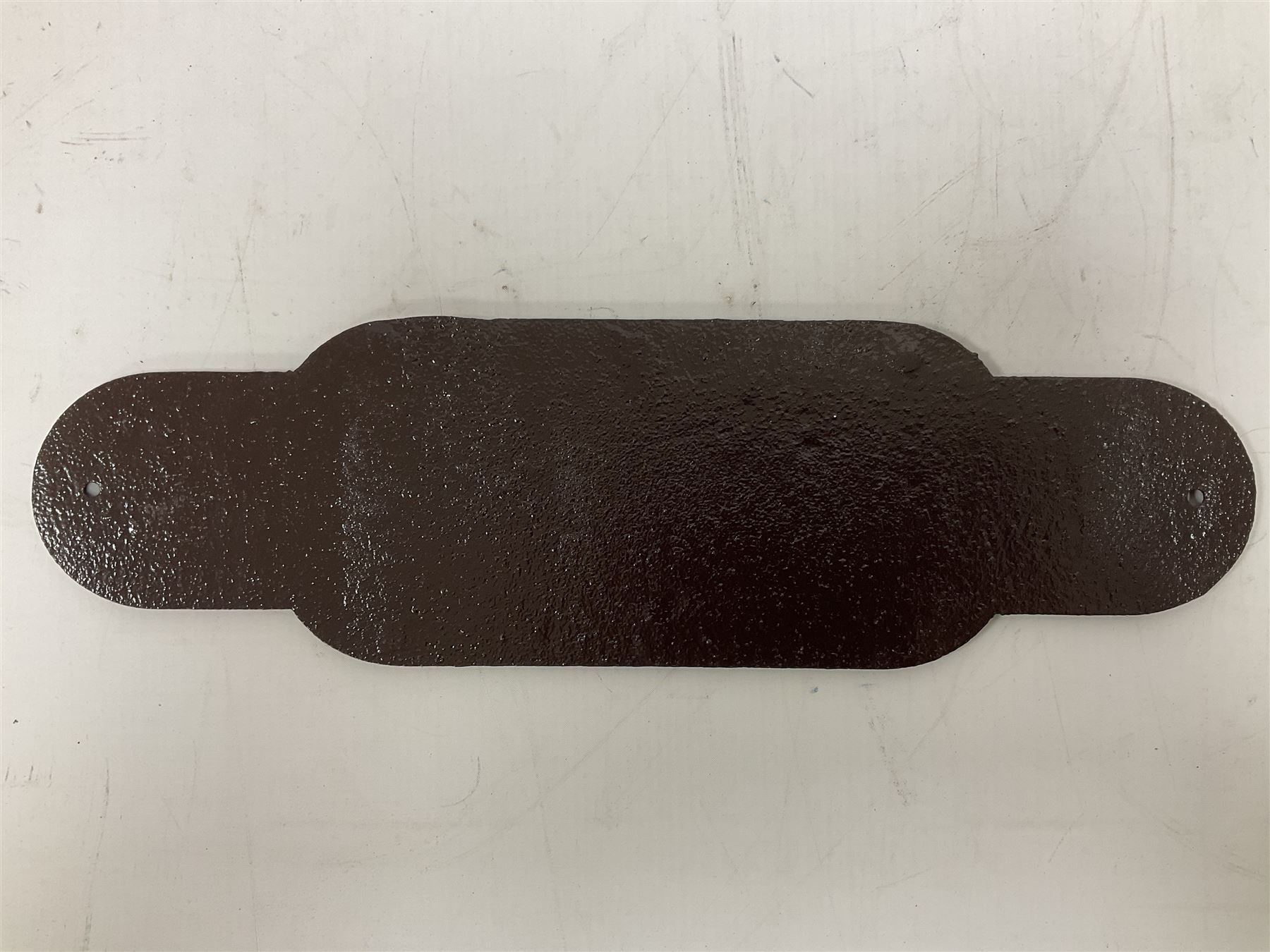 Cast iron Station Master wall plaque on a brown ground, L39cm