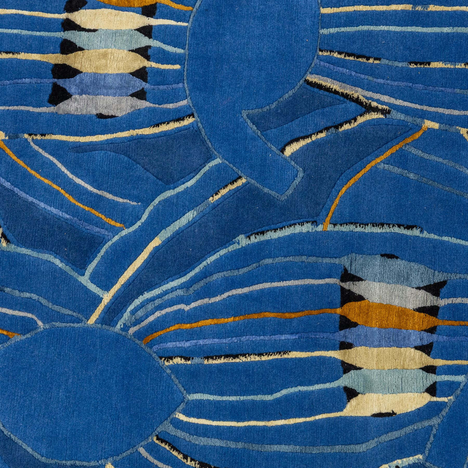 Rugs by Design - ‘Sweet Thames’ Nepalese thick pile wool rug, with abstract stylised floral design in layered blue tones, detailed with linear accents in cream, pale blue, black and ochre tones