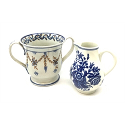 An 18th century Worcester blue and white sparrow beak jug, decorated with floral sprays, with crescent mark beneath, H10.5cm, together with a loving cup, H10.5cm. 