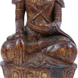 Late 18th century, carved wooden buddha, seated cross legged on a lotus base, with traces of original painted decoration, H35cm 